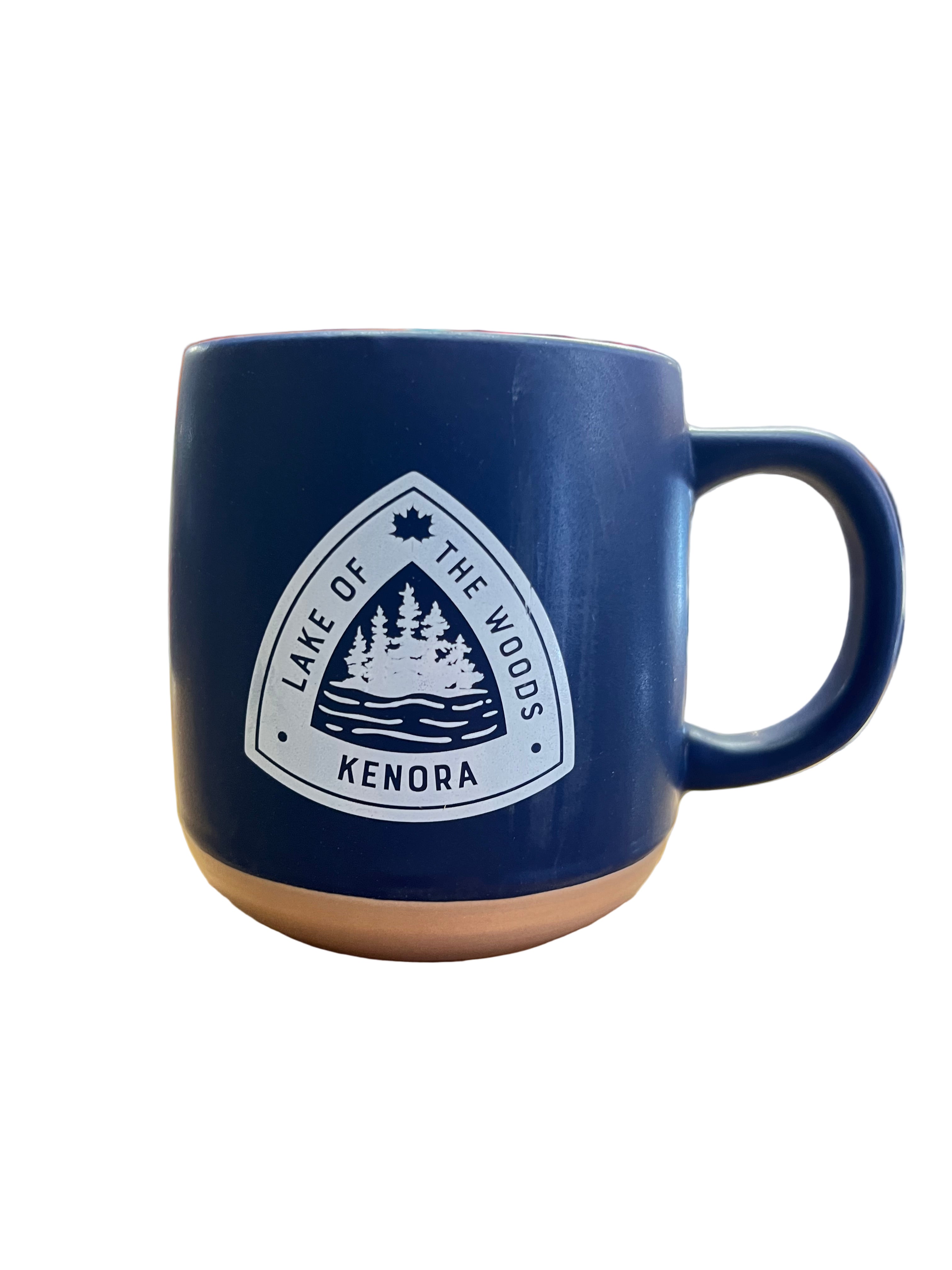 Navy blue mug with a white logo featuring trees and text on a white background