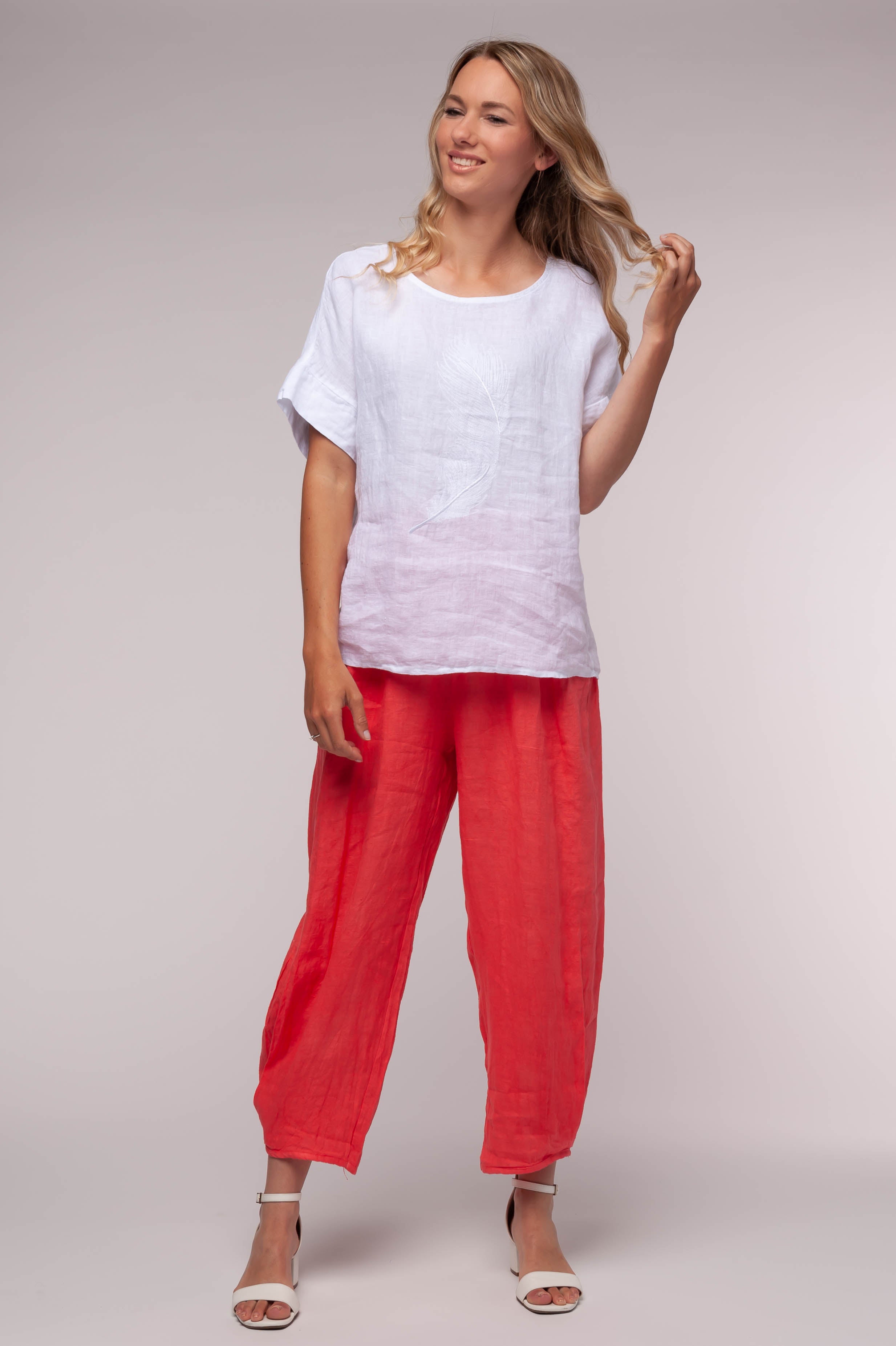 Ladies linen clothing for spring and summer featuring a t-shirt with an embroidered feather on front