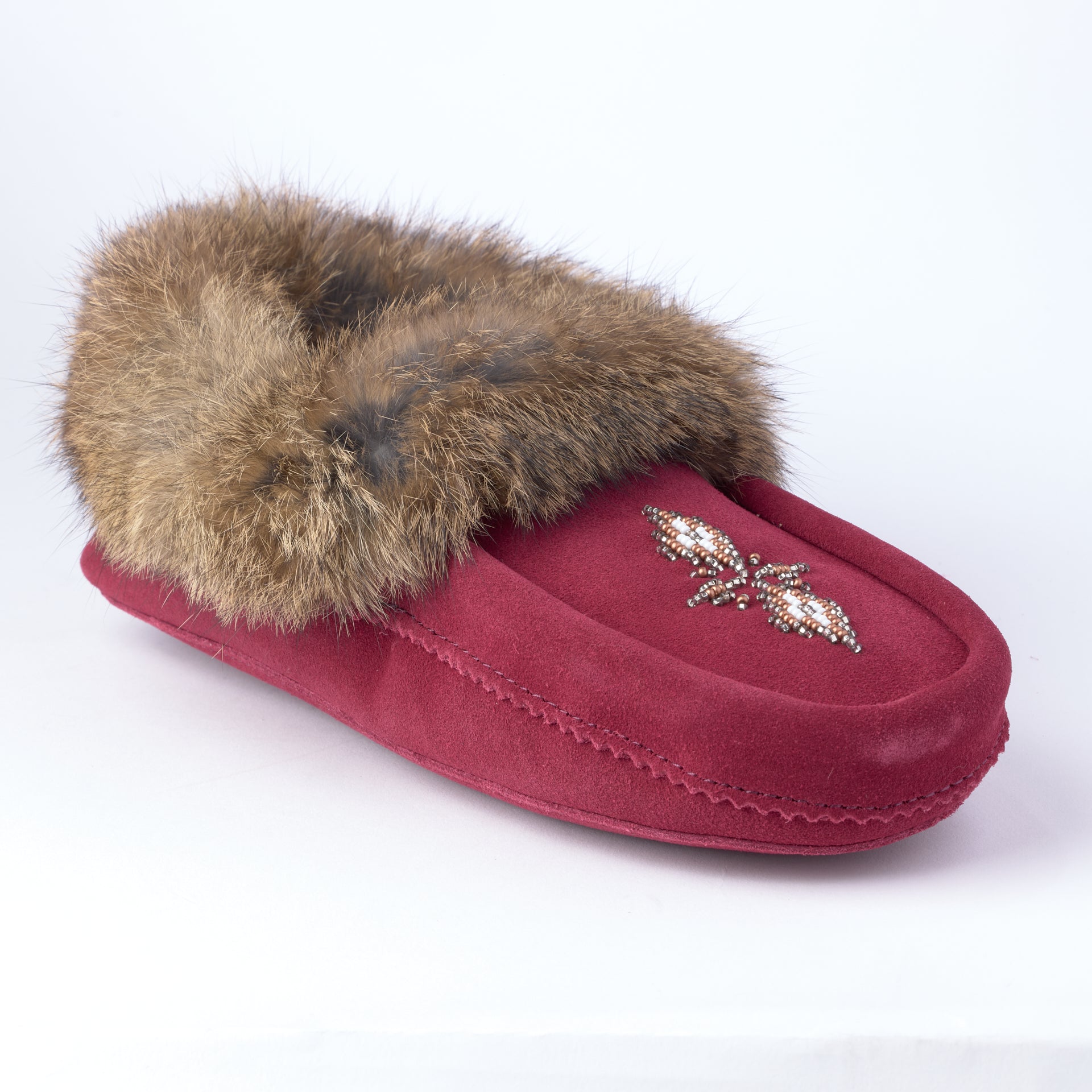 Red slipper with fur trim on a white background