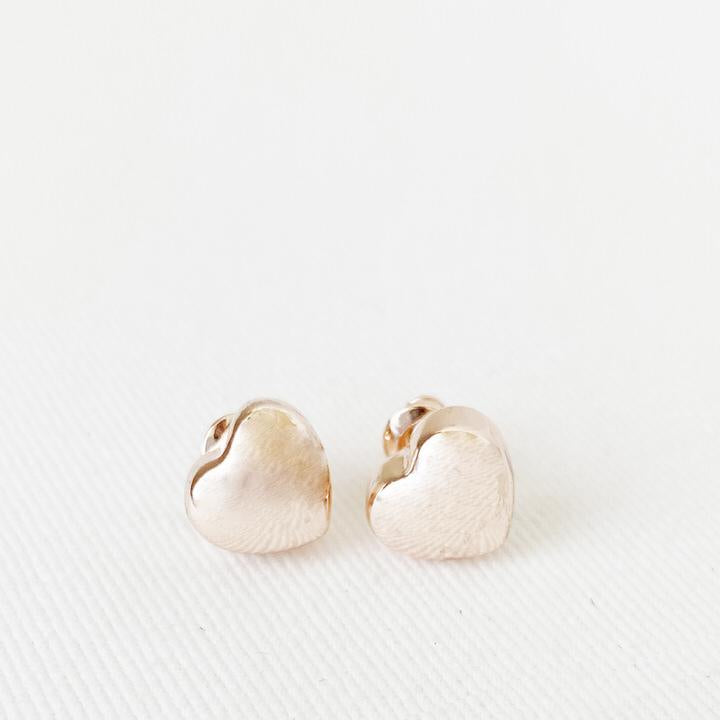 Caracol jewelry featuring a pair of small heart stud earrings