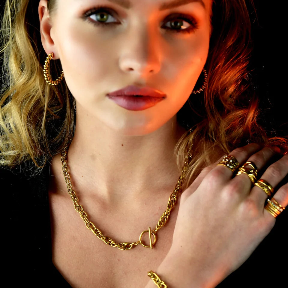 Hackney jewelry featuring a chunky gold intricate multi-chain with circle and T stopper.
