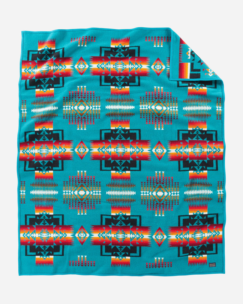 twin size reversible Pendleton wool blanket in turquoise with a bold arrowhead design