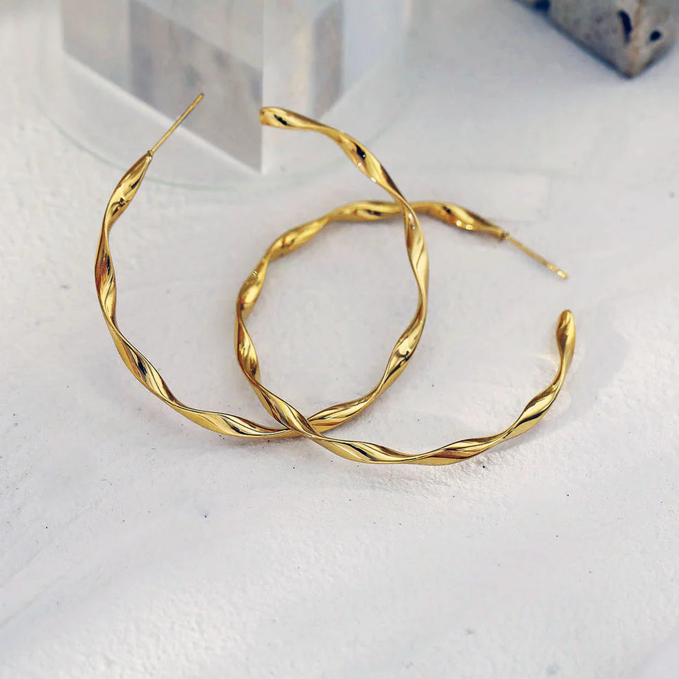Hackney jewelry featuring gold hoop earrings.