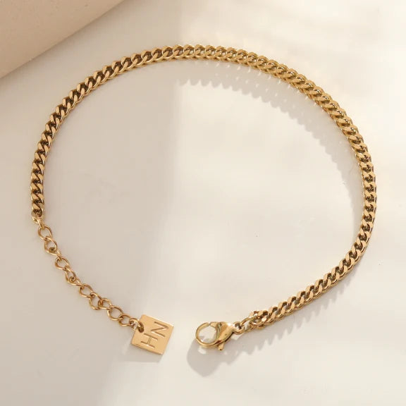 Hackney jewelry featuring a gold link chain bracelet.