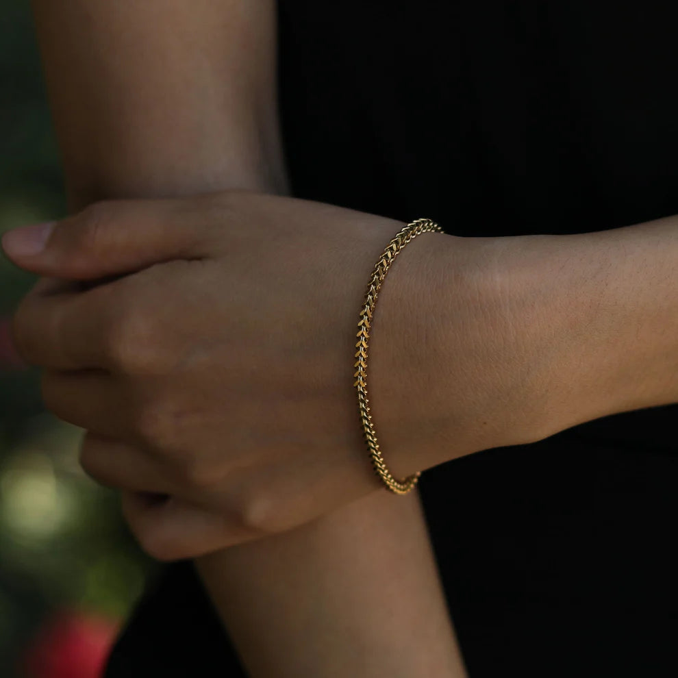 Hackney jewelry featuring a gold link chain bracelet.