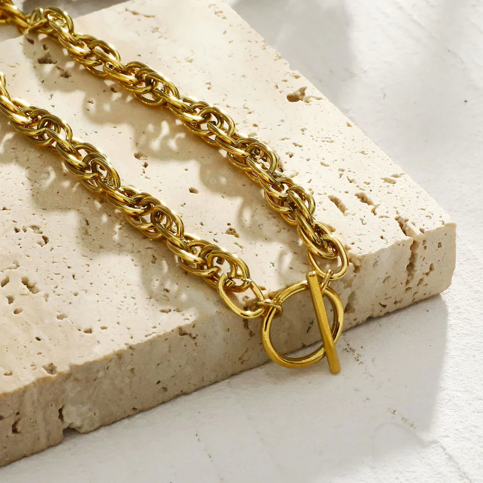 Hackney jewelry featuring a chunky gold intricate multi-chain with circle and T stopper.