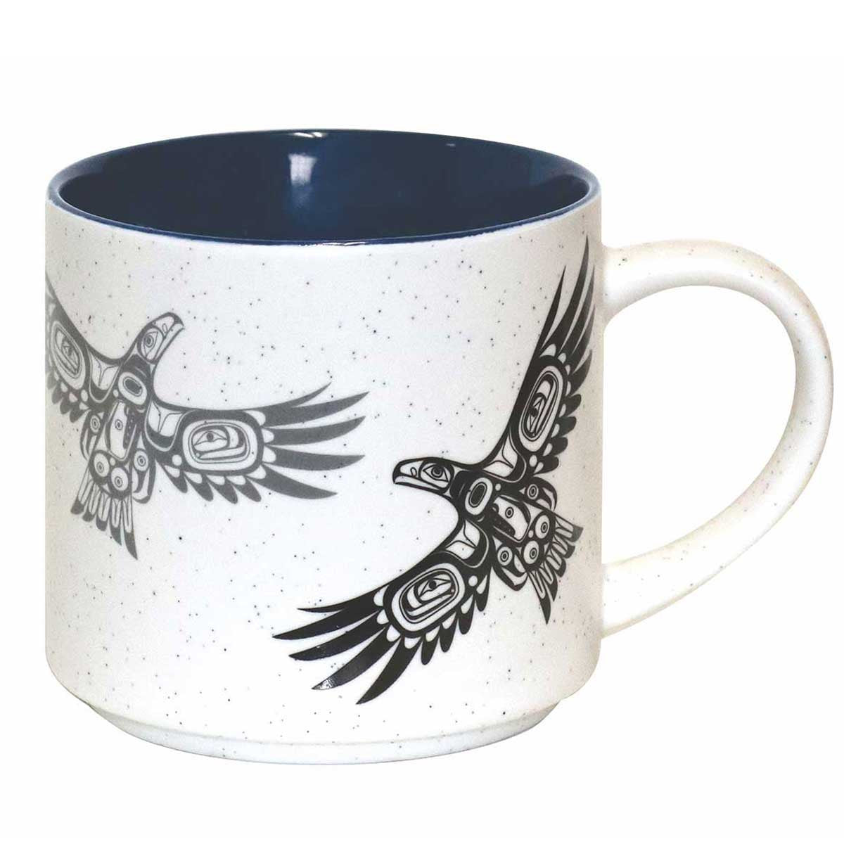 A ceramic coffee mug featuring an Indigenous design of eagles from the Bella Bella tribe