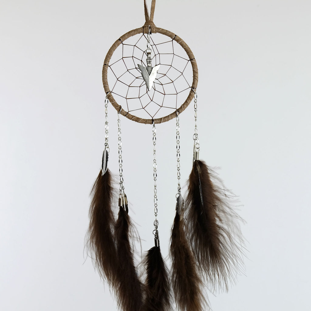 Handmade dream catcher with chain dangles detailed with metal feather charms and a metal arrowhead in the middle of the web.