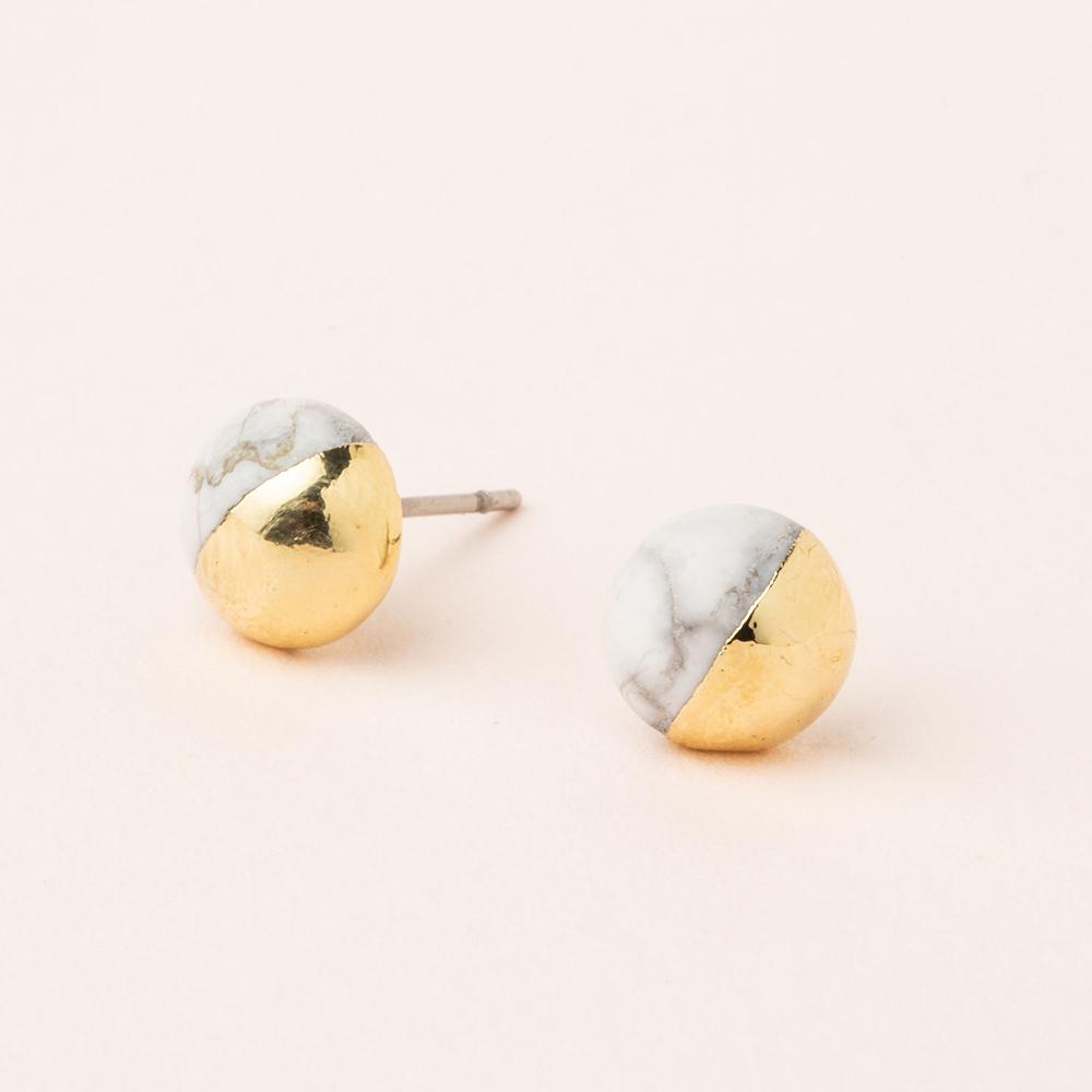 Scout jewelry featuring a pair of stud earrings