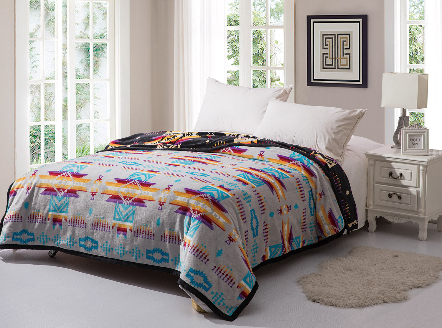 Grey reversible to black fleece blanket with traditional native designs. Comes in twin, queen, and king.