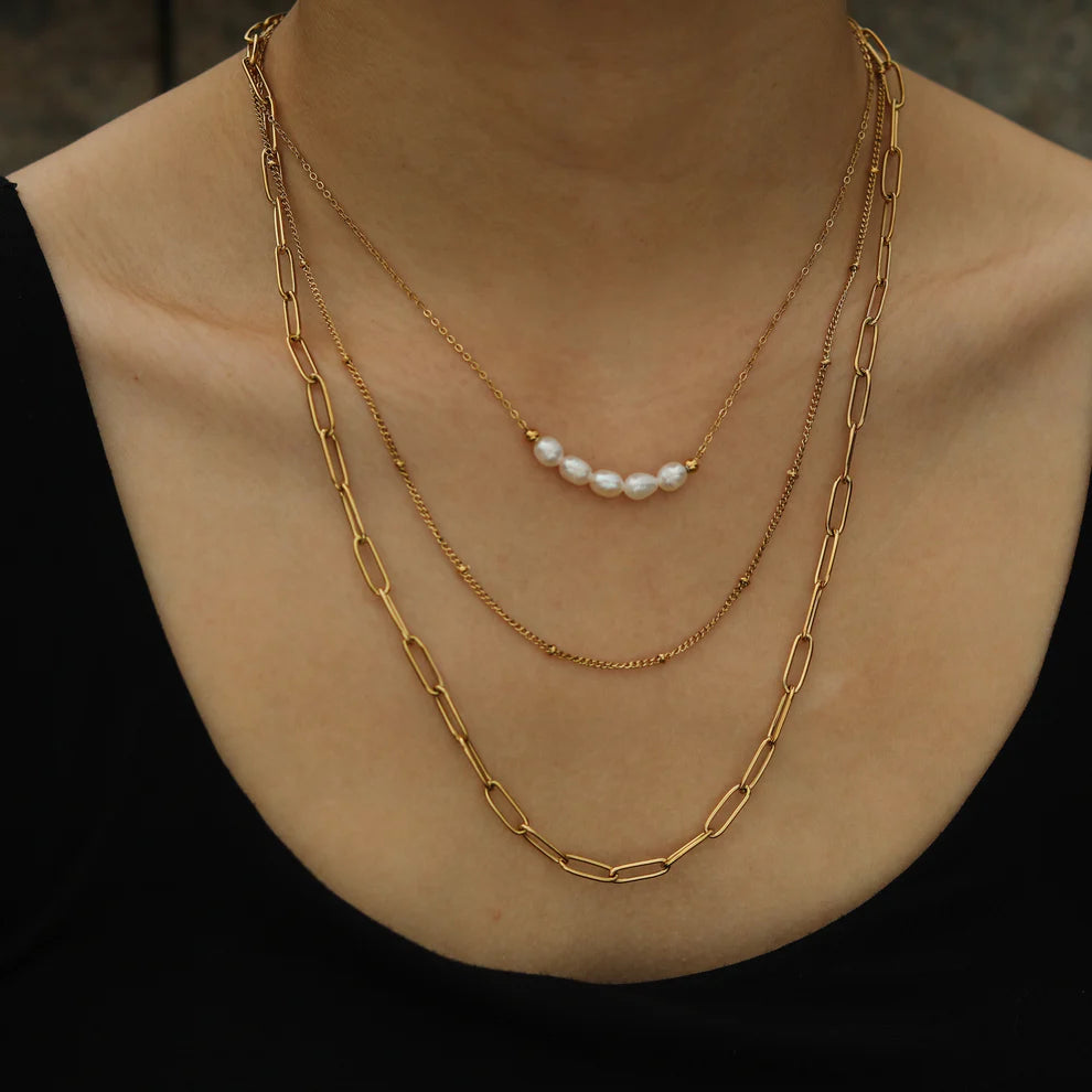 Hackney jewelry featuring 3-layer multi chain gold necklaces with natural pearls.
