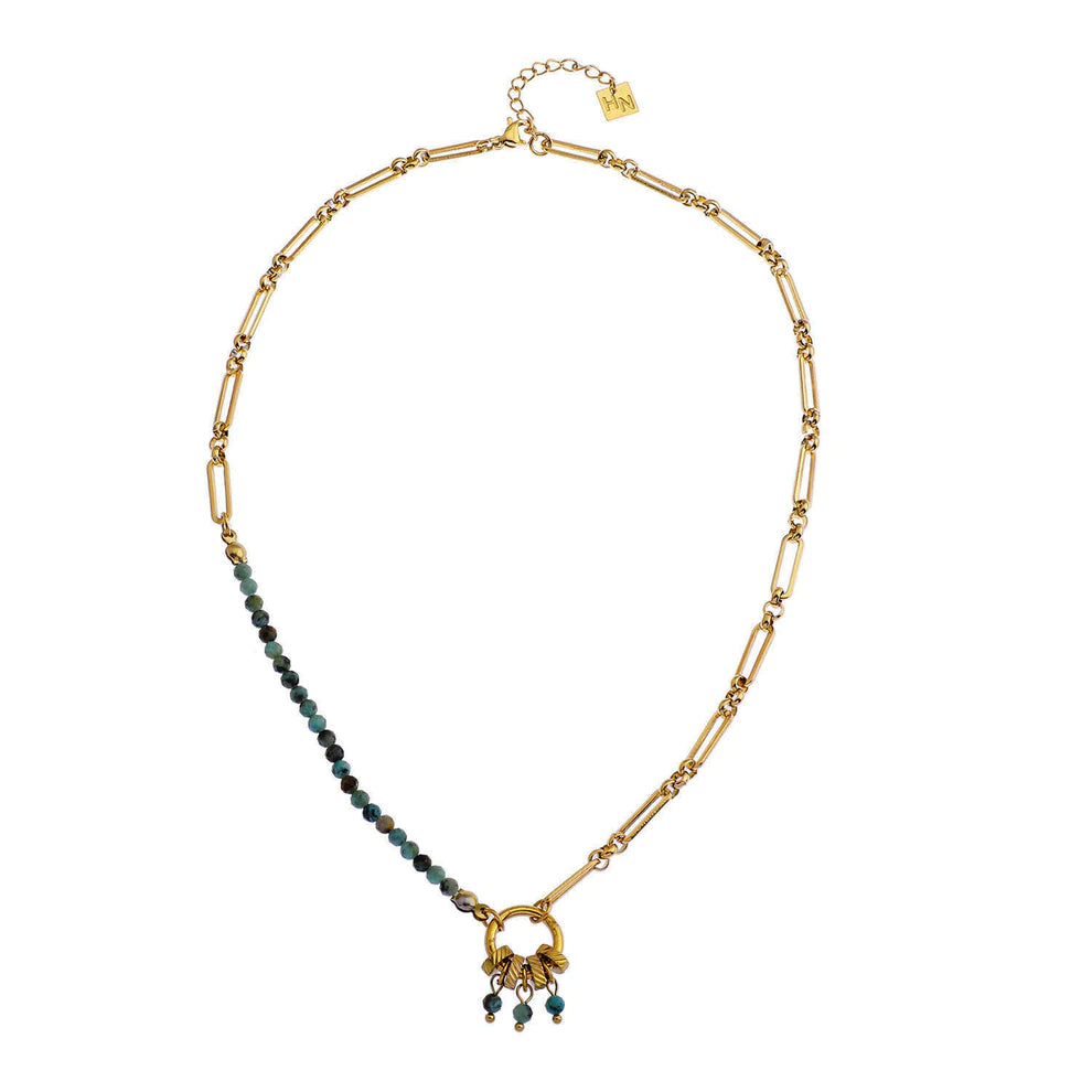 Hackney jewelry featuring a turquoise natural sone charm pendant on gold necklace.