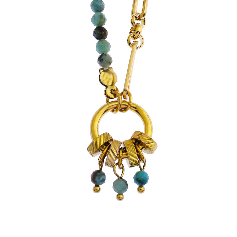 Hackney jewelry featuring a turquoise natural sone charm pendant on gold necklace.