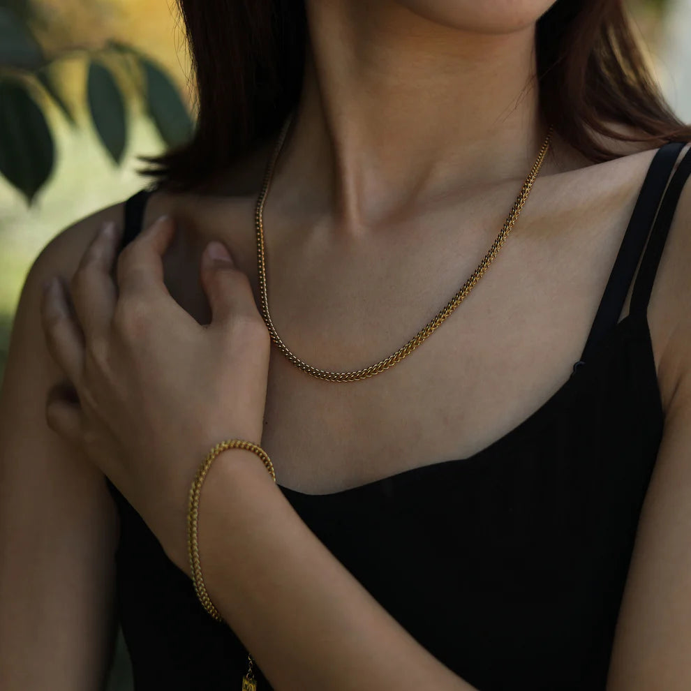 Hackney jewelry featuring a gold link chain bracelet.
