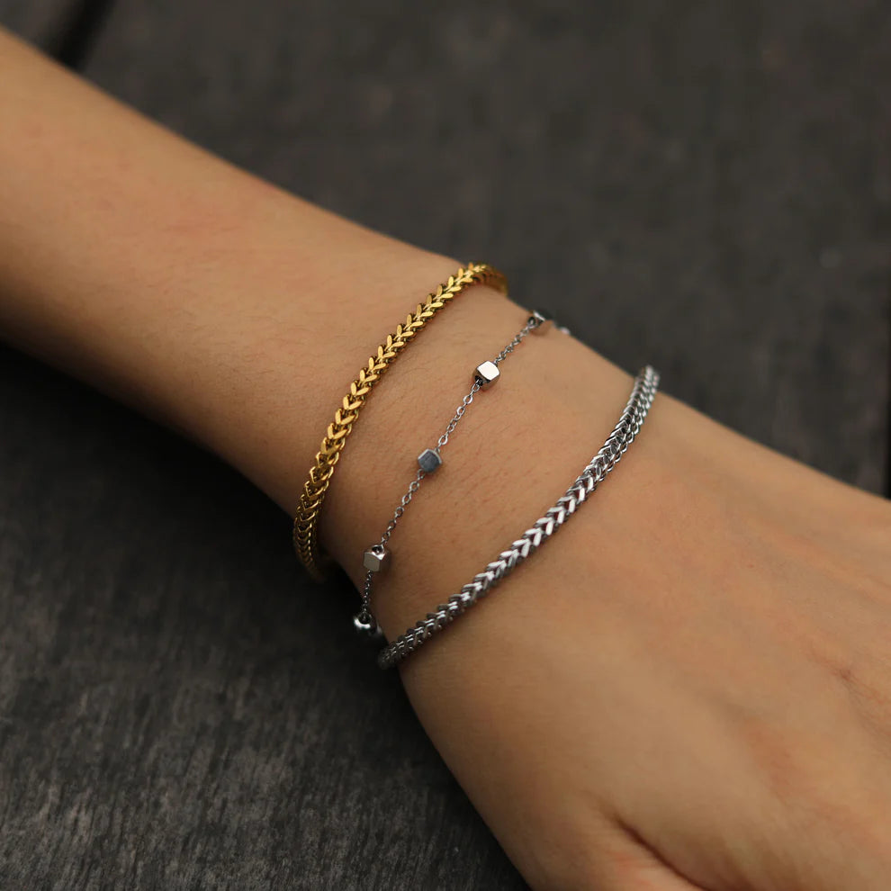 Hackney jewelry featuring a gold link chain bracelet.