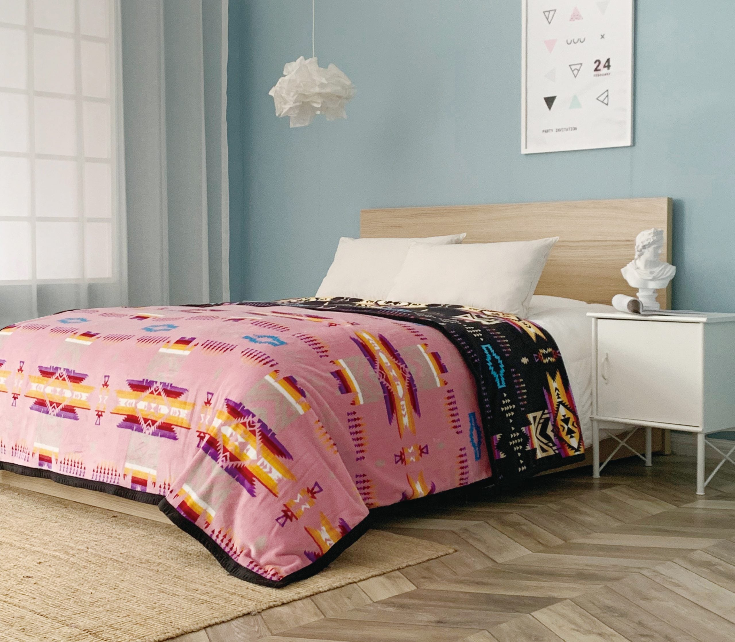 Pink reversible to black fleece blanket with traditional native designs. Comes in twin, queen, and king.