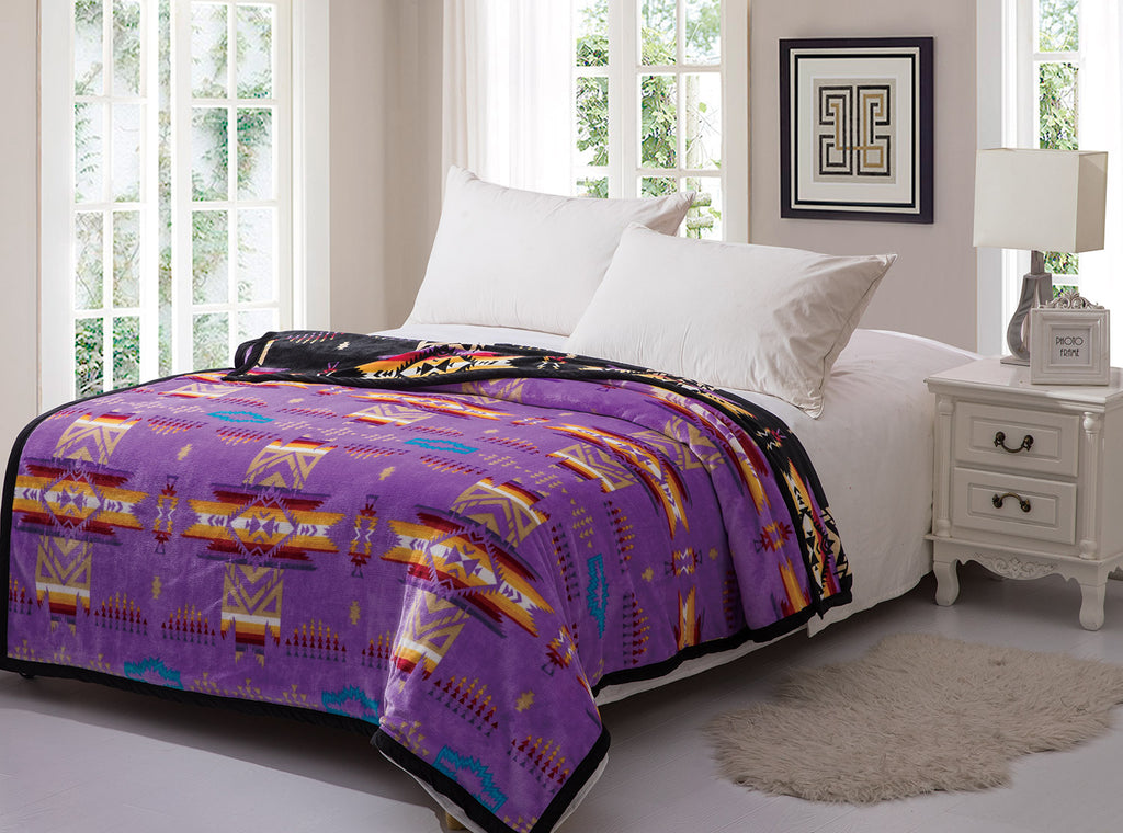 Purple reversible to black fleece blanket with traditional native designs. Comes in twin, queen, and king.