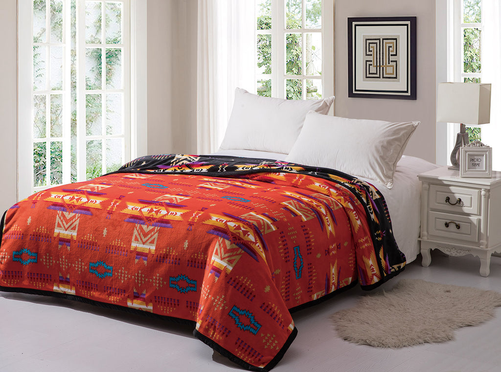 Red reversible to black fleece blanket with traditional native designs. Comes in twin, queen, and king.