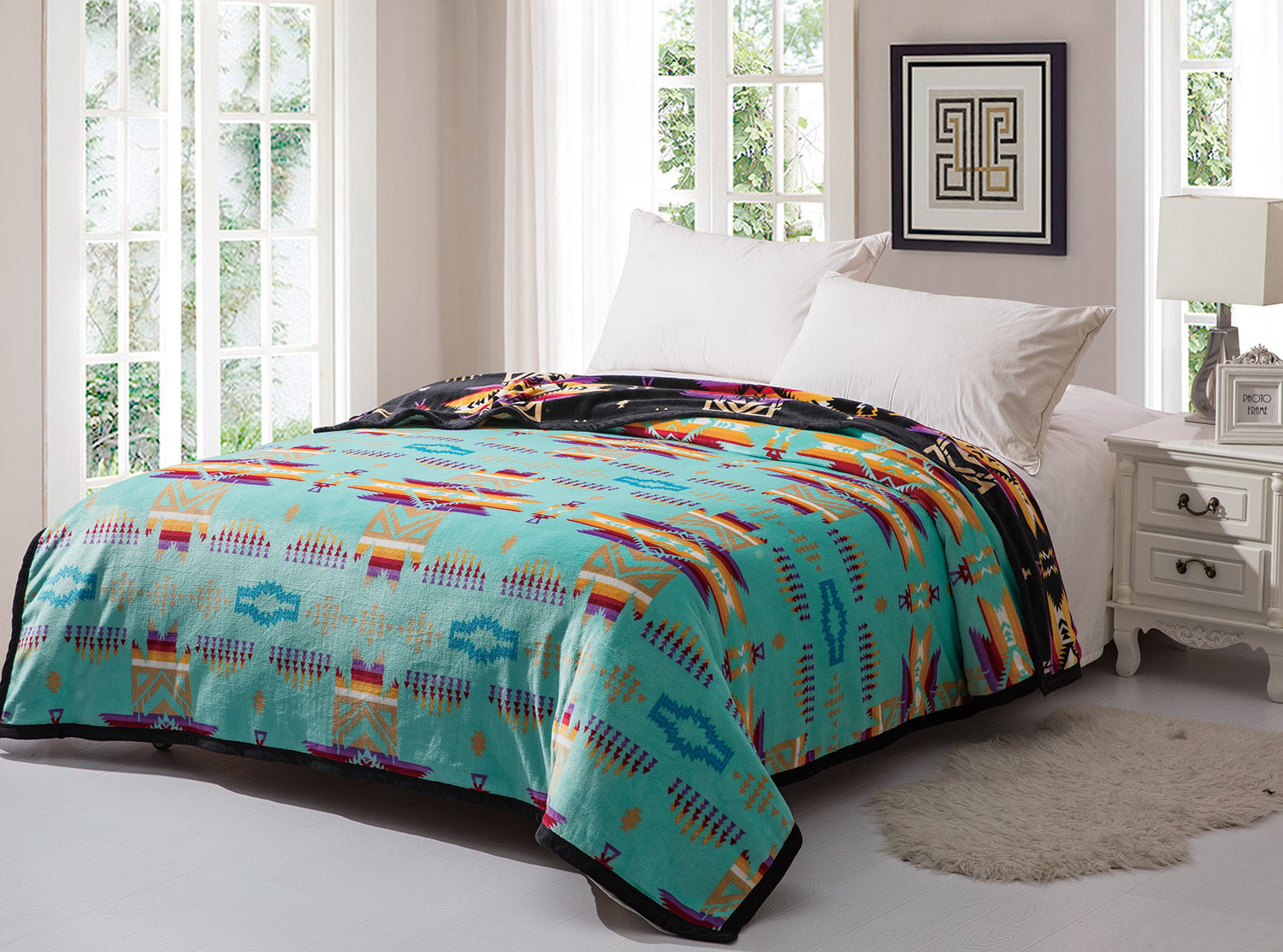 Aqua reversible to black fleece blanket with traditional native designs. Comes in twin, queen, and king.