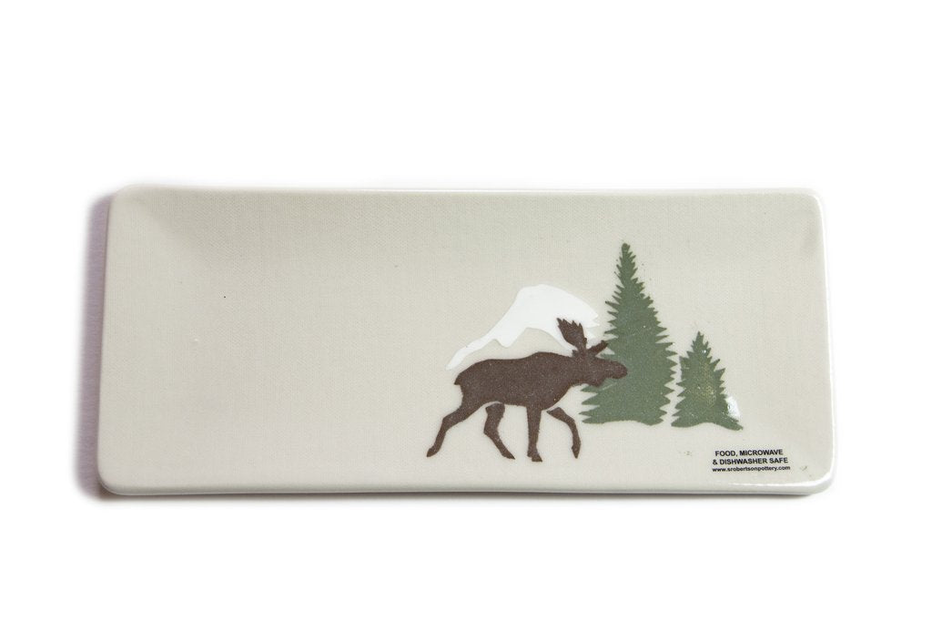 Stoneware clay serving plate with painted moose motif. Handmade in Outlook, Saskatchewan by Susan Robertson Pottery. Use decoratively or as a serving plate for small dishes or appetizers. Food, Microwave and Dishwasher safe. Dimensions: Approximately 11” x 4”