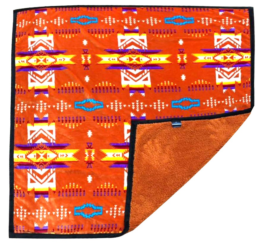 Terracotta fleece throw blanket with traditional native designs.