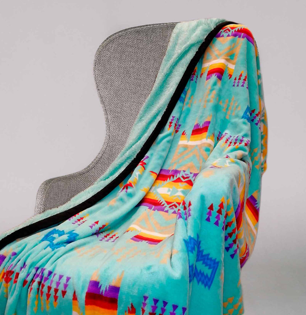 Aqua fleece throw blanket with traditional native designs.
