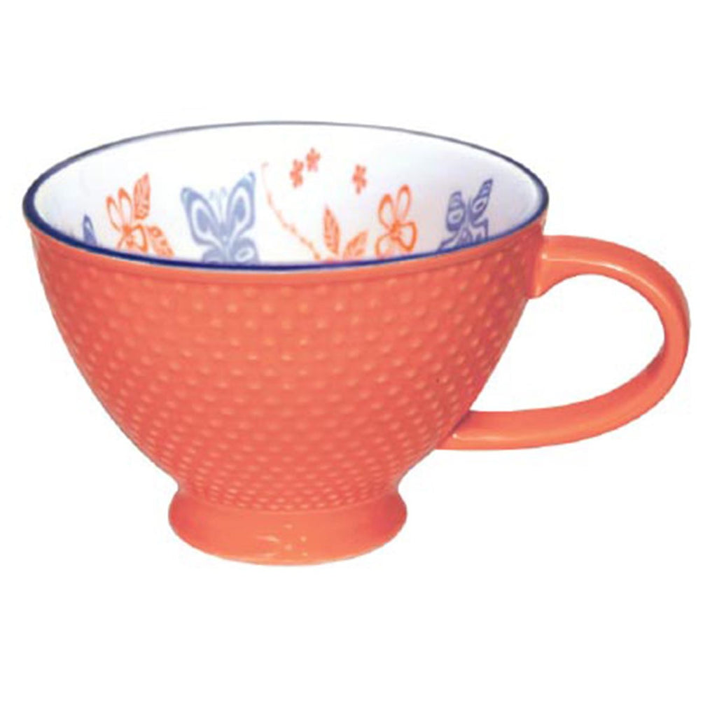 An orange mug with a textured exterior and an Indigenous butterfly patterned interior.