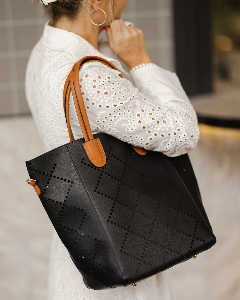 Vegan leather Louenhide bag featuring the 2 in 1 Bermuda purse with laser cut diamond shape design and an extra adjustable strap. 