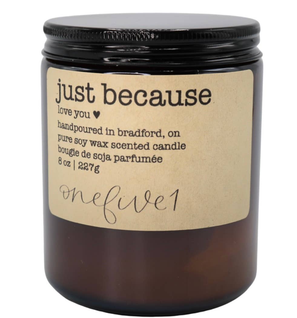 Candle with a label reading 'just because' on a white background