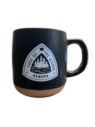 Black mug with a black Lake of the Woods souvenir logo on a white background