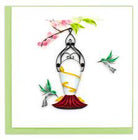 Perfect card for love, good luck and joy  for an occasion handcrafted with a hummingbird feeder hanging from a pink flowery branch with two green and gray hummingbirds hovering around the feeder.