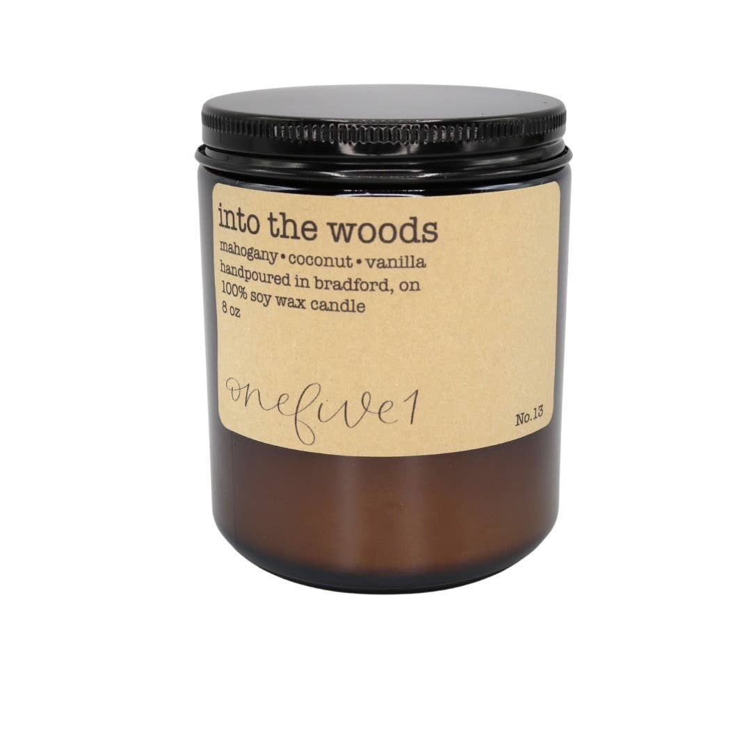 Candle labeled 'into the woods' with a brown label on a white background