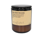 Candle labeled 'into the woods' with a brown label on a white background
