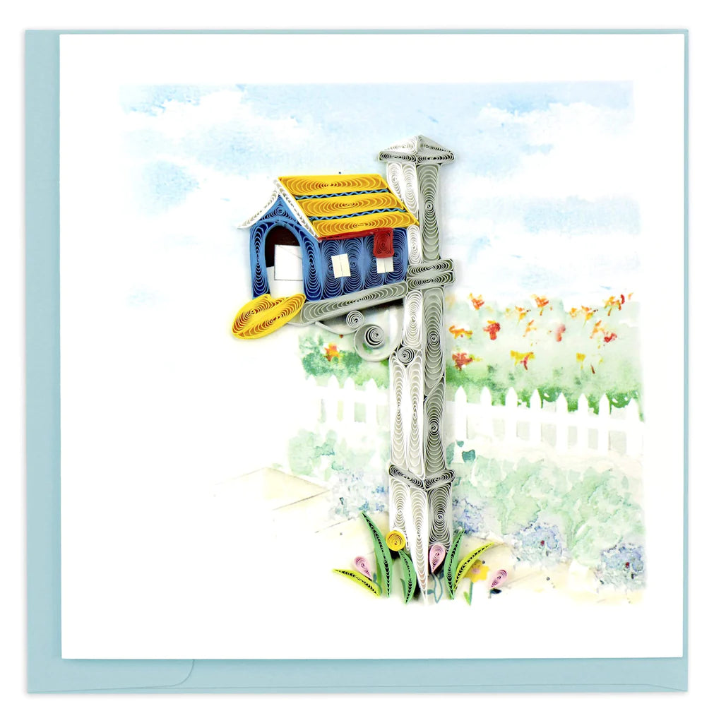 Congratulating card for friends and loved ones on their new home handcrafted with a blue mailbox with a yellow roof, set upon a grey and white post on a bright and sunny day. 
