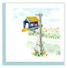 Congratulating card for friends and loved ones on their new home handcrafted with a blue mailbox with a yellow roof, set upon a grey and white post on a bright and sunny day. 