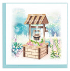 Greeting card to make someone's wish come true! handcrafted traditional stone and wood wishing well in a beautiful garden with flowers also blooming from inside the well.