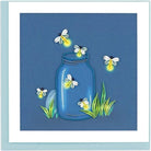 Fireflies greeting handcrafted card with a mason jar filled with quilled fireflies sitting in a small patch of grass on a printed background of dark blue.