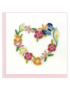 Perfect card for all occasion with the outline of a heart made of colorful spring flowers with a blue butterfly perched at the top left.