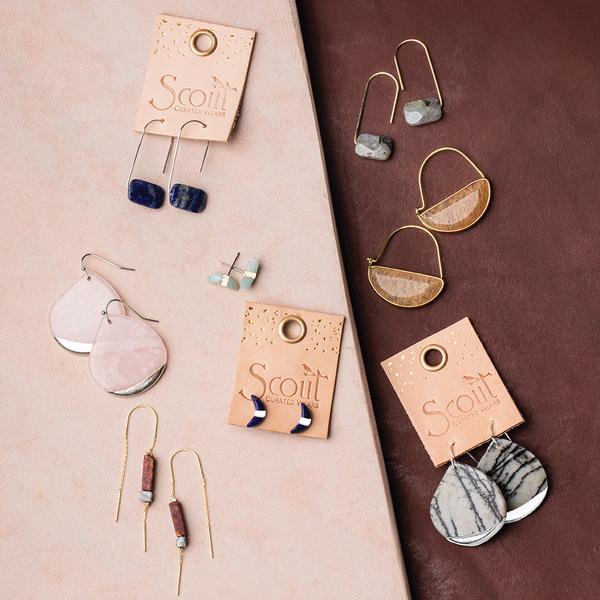 Scout jewelry featuring a pair of stud earrings