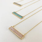 Caracol jewelry featuring a delicate chain necklace with stone pendant