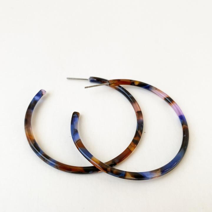 Caracol jewelry featuring a pair of medium sized multi coloured hoop earrings