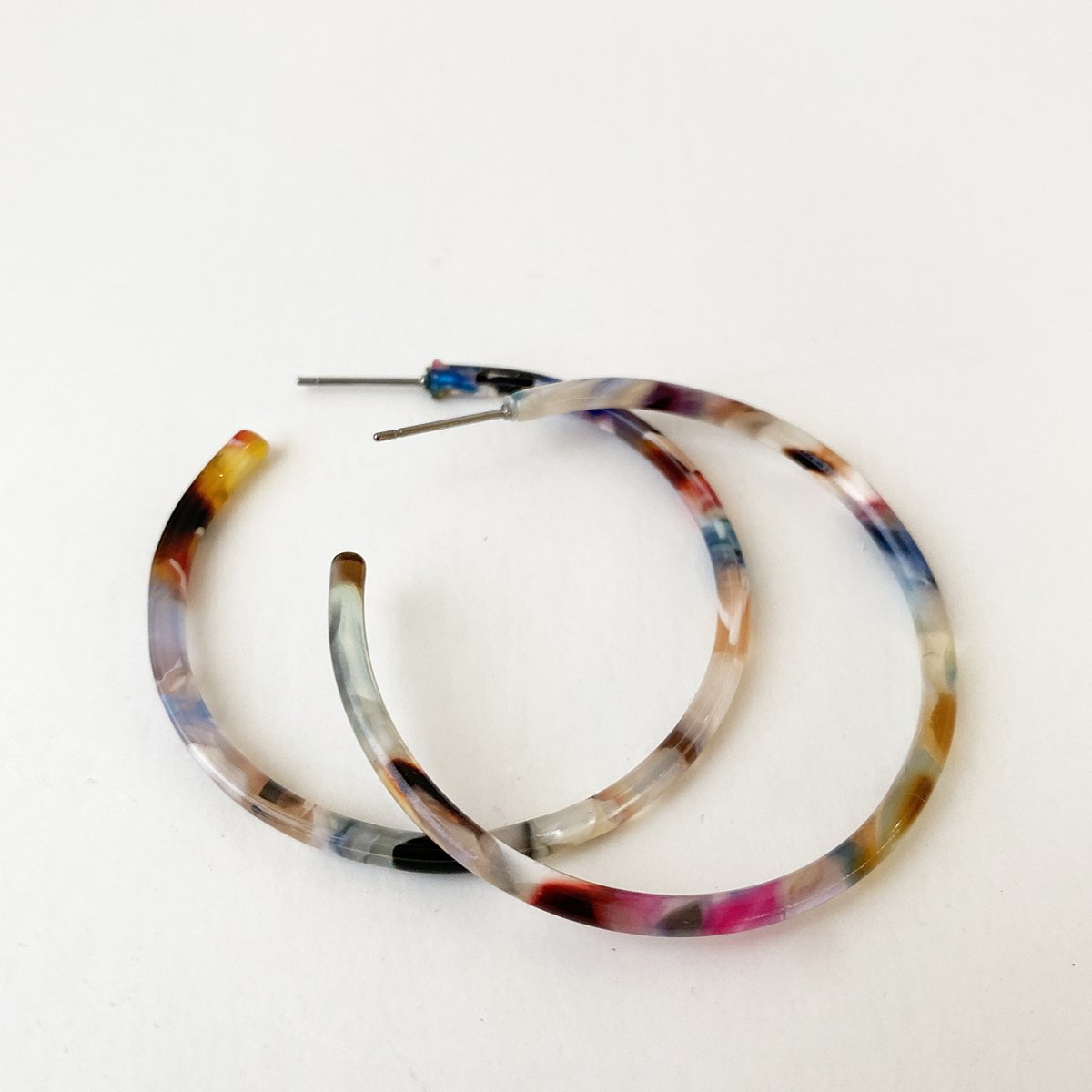 Caracol jewelry featuring a pair of medium sized multi coloured hoop earrings