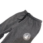 A pair of dark grey sweatpants with a Lake of the Woods Clothing Company logo design printed on the top left front leg. These sweatpants are made in Canada and are fit for men and women