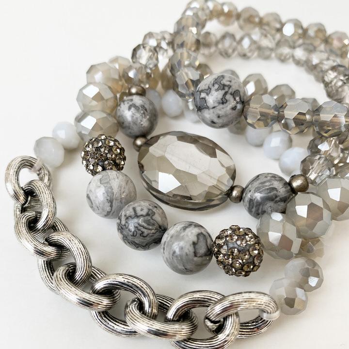 Caracol jewelry featuring a set of four bracelets with glass, stones, and metal beads