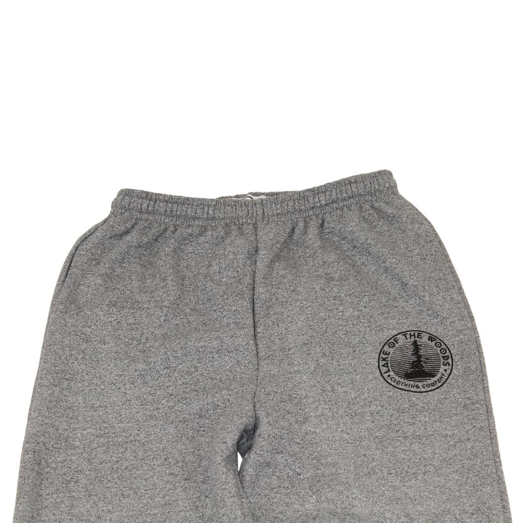 A pair of salt & pepper sweatpants with a Lake of the Woods Clothing Company logo design printed on the top left front leg. These sweatpants are made in Canada and are fit for men and women