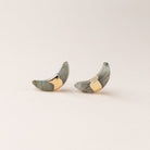 Scout jewelry featuring a pair of stud earrings
