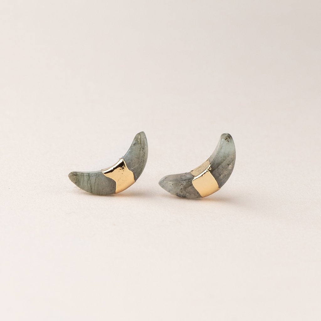 Scout jewelry featuring a pair of stud earrings