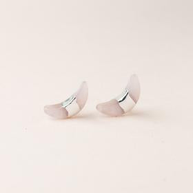 Scout jewelry featuring a pair of stud earrings