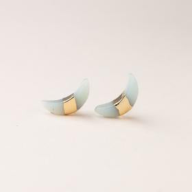 Scout jewelry featuring a pair of stud earrings