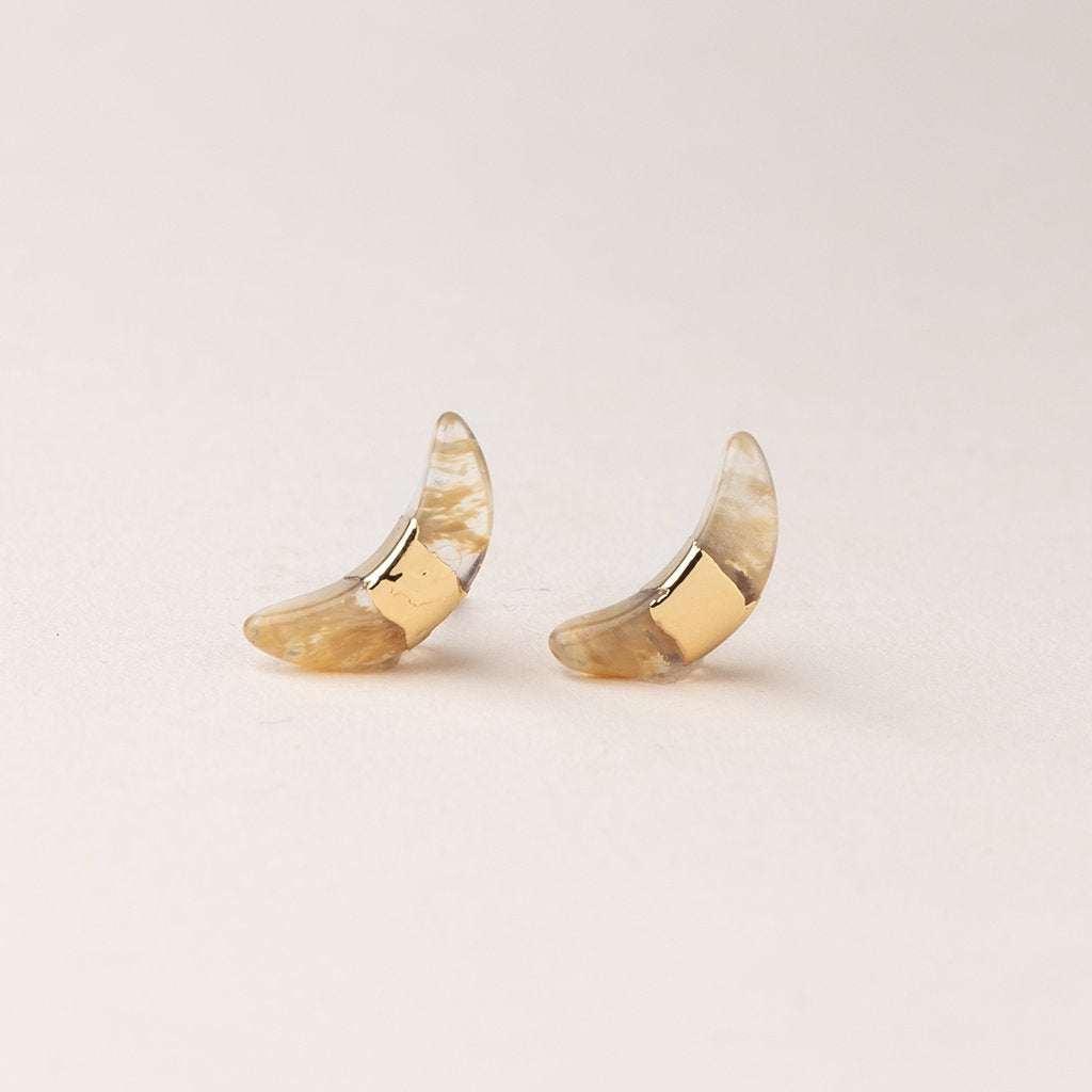 Scout jewelry featuring a pair of stud earrings